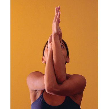 A picture of a woman doing yoga with her arms entwined.